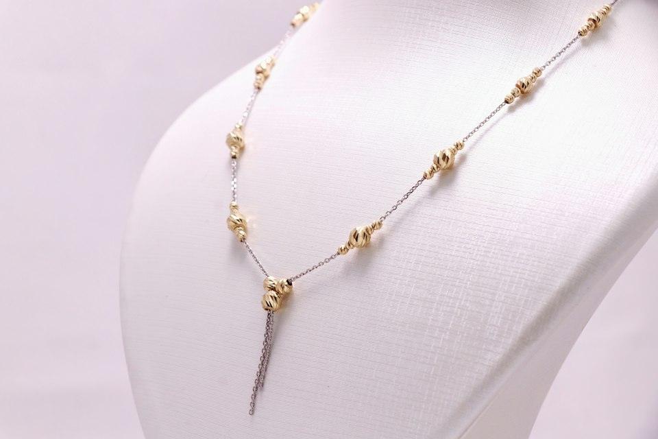 A white mannequin with a necklace on it
