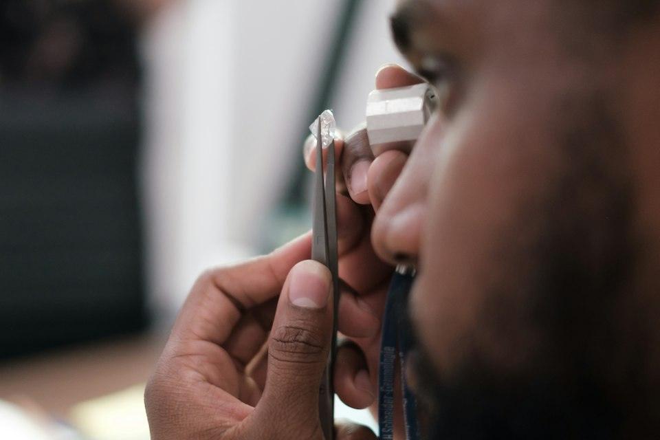 A man using a stethoscope to examine a person's ear