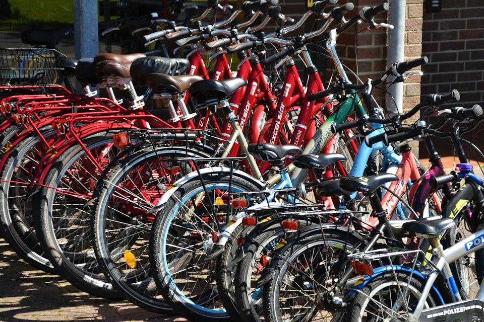Lined red, blue, and black bicycles on display