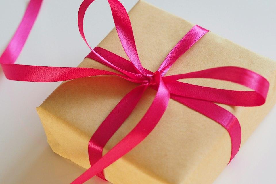Brown gift box with pink ribbon