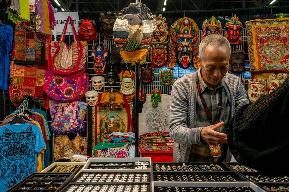 Man selling jewelry and decorative items at a market stall