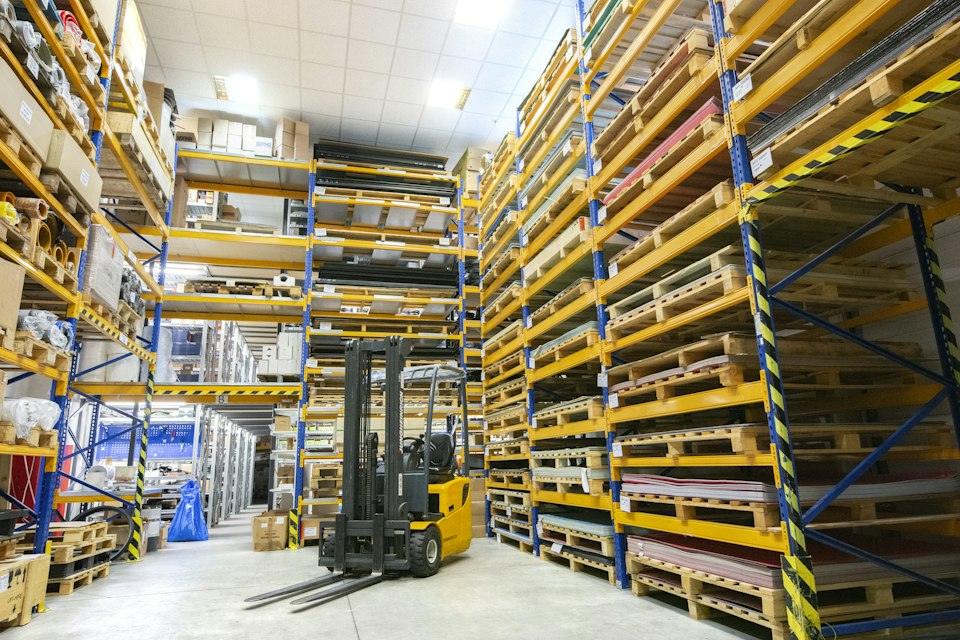 A large warehouse filled with lots of pallets