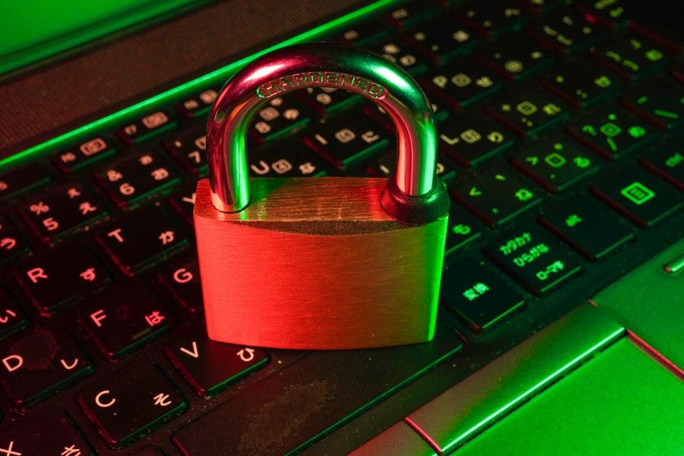 Red padlock on black computer keyboard