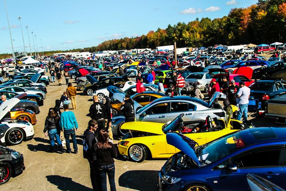 People standing beside blue and yellow cars during daytime