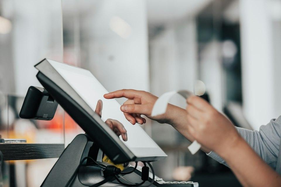 A person is using a pos machine in a store