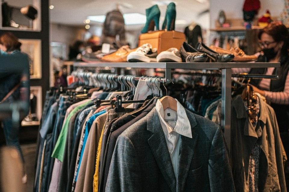 A rack of clothes and shoes in a store