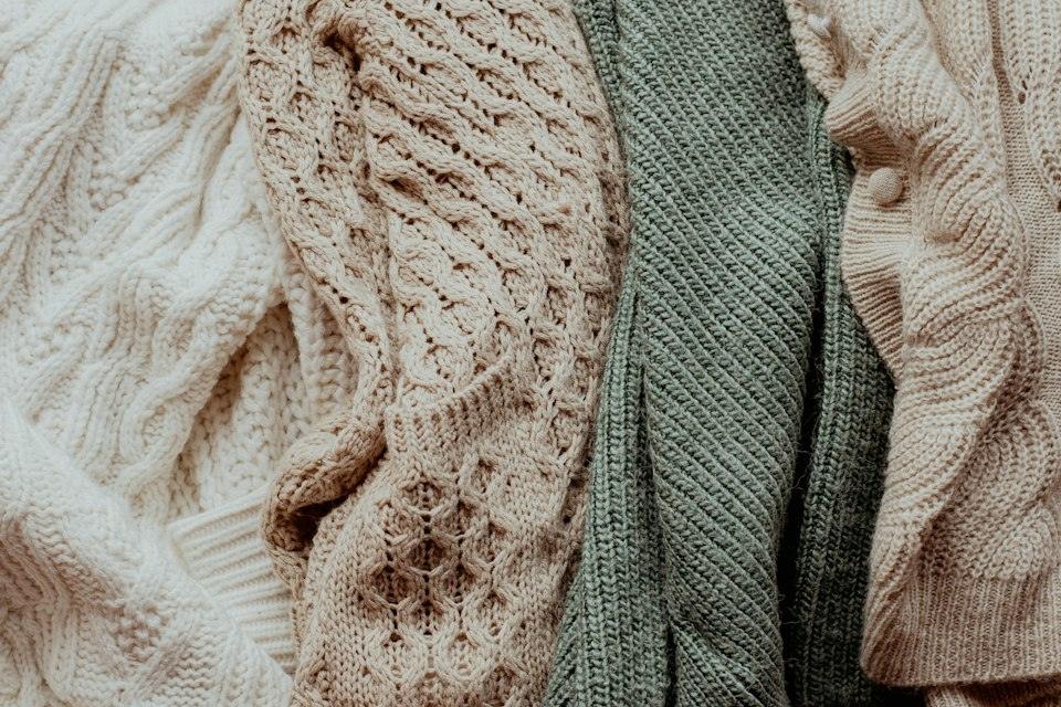 A pile of sweaters sitting next to each other