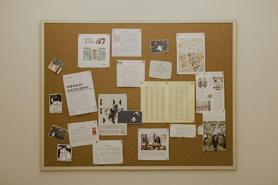 A bulletin board covered in papers and pictures