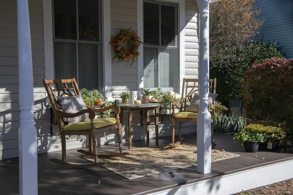 Brown wooden chairs and table near white wooden post